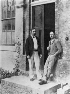 Charles Smart Roy and Charles Scott Sherrington (right), at the door of the Old Pathological Laboratory, Cambridge, 1893.