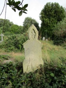 The headstone is intact but the inscription barely legible.  Photo 2016